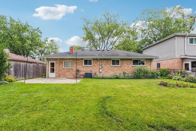 404 Virginia Pl, Wheeling, IL 60090 - rear view of house with a patio area, brick siding, and a chimney