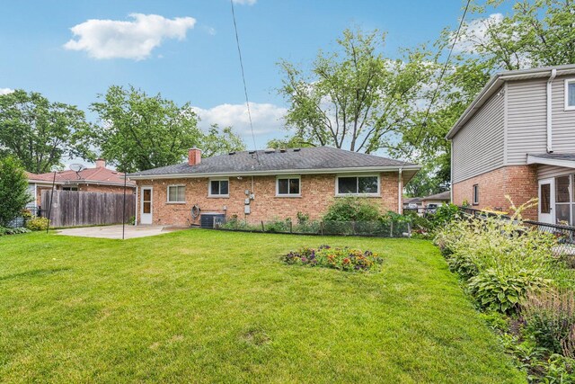 404 Virginia Pl, Wheeling, IL 60090 - rear view of house featuring a patio, brick siding, and a chimney