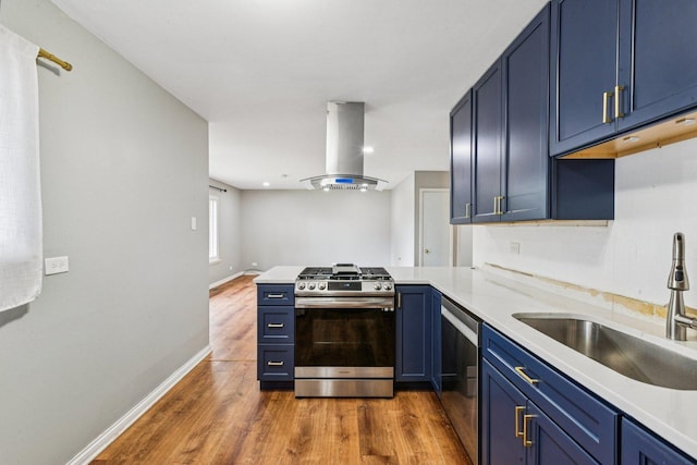404 Virginia Pl, Wheeling, IL 60090 - kitchen with stainless steel appliances, island exhaust hood, blue cabinets, and a peninsula