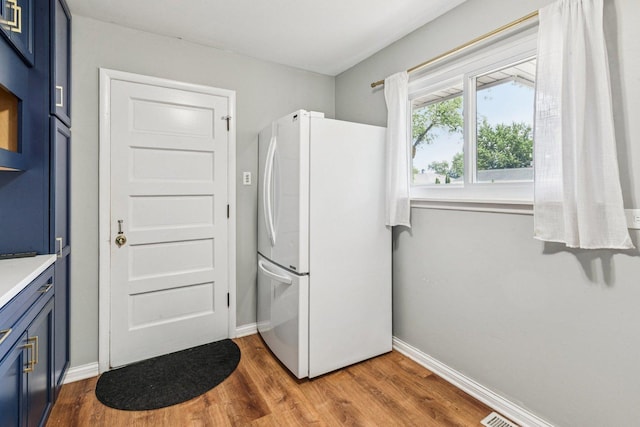 404 Virginia Pl, Wheeling, IL 60090 - kitchen with blue cabinetry, freestanding refrigerator, and dark wood-type flooring