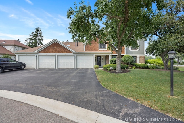 1675 Grosvenor Cir Unit D, Wheaton, IL 60189 - view of front of house with a front yard, an attached garage, and driveway