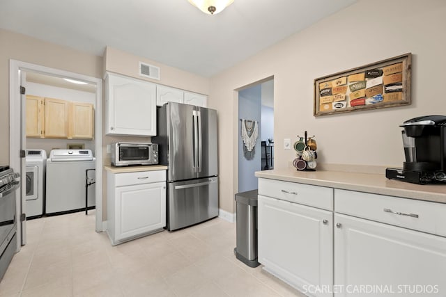1675 Grosvenor Cir Unit D, Wheaton, IL 60189 - kitchen with appliances with stainless steel finishes, washer and clothes dryer, light countertops, and white cabinets