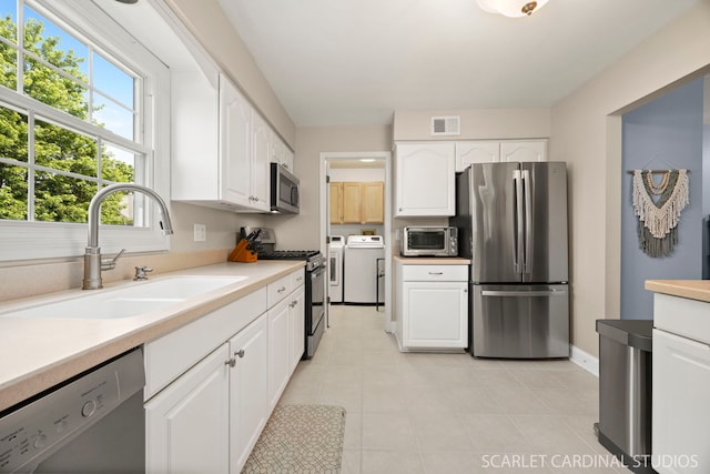 1675 Grosvenor Cir Unit D, Wheaton, IL 60189 - kitchen with stainless steel appliances, washer and dryer, white cabinets, and light countertops