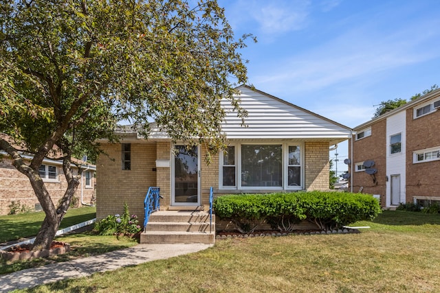 5128 Suffield Ct, Skokie, IL 60077 - bungalow-style home with a front lawn and brick siding