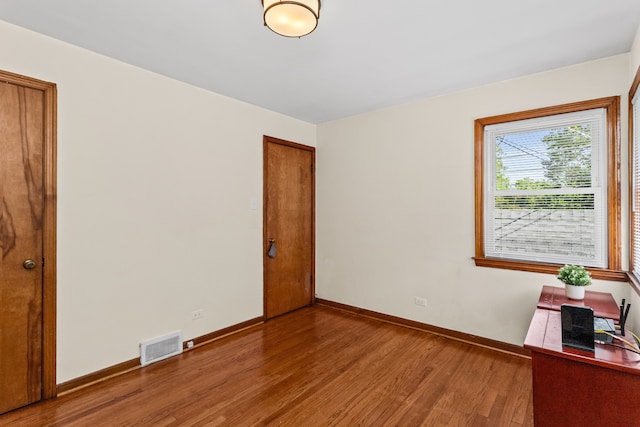 5128 Suffield Ct, Skokie, IL 60077 - empty room with wood finished floors and baseboards