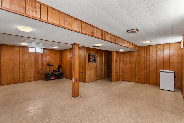 5128 Suffield Ct, Skokie, IL 60077 - below grade area featuring tile patterned floors, wood walls, and refrigerator