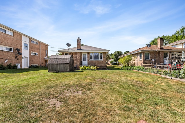 5128 Suffield Ct, Skokie, IL 60077 - rear view of property with a storage unit, a lawn, brick siding, and a chimney