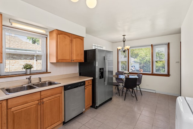 5128 Suffield Ct, Skokie, IL 60077 - kitchen with appliances with stainless steel finishes, a chandelier, light countertops, light tile patterned floors, and hanging light fixtures
