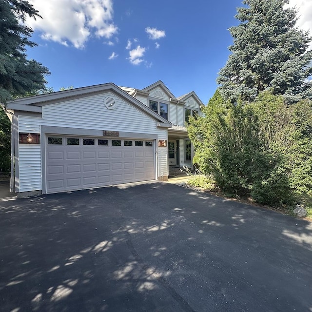 724 Cimarron Dr, Cary, IL 60013 - view of front facade with asphalt driveway and an attached garage