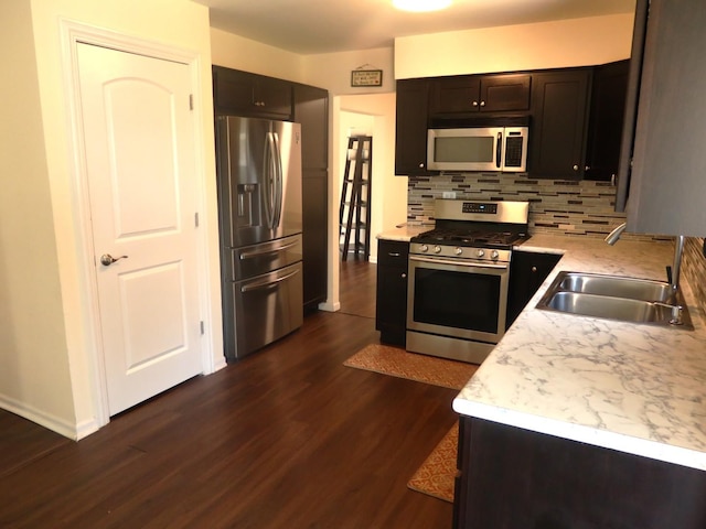 1010 Trillium Ln, Bartlett, IL 60103 - kitchen with appliances with stainless steel finishes, dark wood-type flooring, decorative backsplash, and light countertops