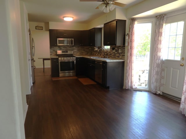 1010 Trillium Ln, Bartlett, IL 60103 - kitchen with appliances with stainless steel finishes, a ceiling fan, dark wood-style floors, light countertops, and decorative backsplash