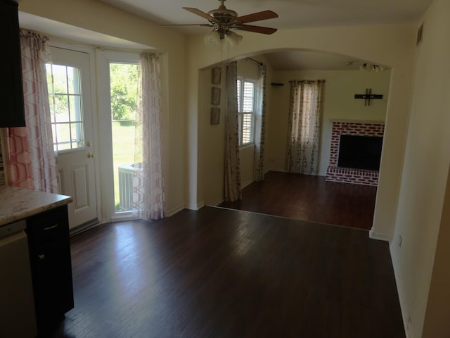 1010 Trillium Ln, Bartlett, IL 60103 - unfurnished living room featuring arched walkways, healthy amount of natural light, ceiling fan, and dark wood finished floors