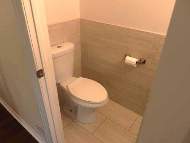 1010 Trillium Ln, Bartlett, IL 60103 - bathroom with tile walls, tile patterned floors, and a wainscoted wall