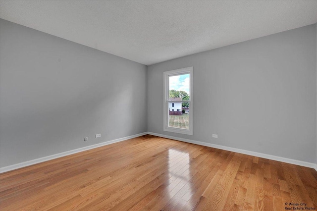 1718 Ardwick Dr, Hoffman Estates, IL 60169 - empty room featuring light wood-style flooring and a textured ceiling