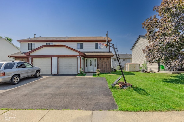 2123 Mallard Ln, Hanover Park, IL 60133 - view of property featuring an attached garage, driveway, a front lawn, and brick siding