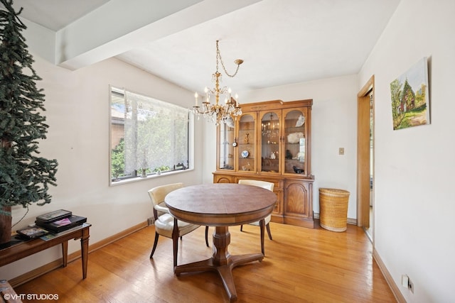 2555 Stratford Ave, Westchester, IL 60154 - dining room with a chandelier and light wood-style flooring