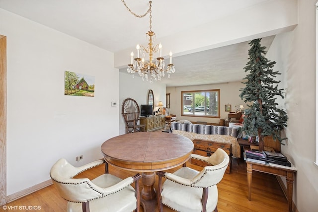 2555 Stratford Ave, Westchester, IL 60154 - dining room with light wood-type flooring and a chandelier