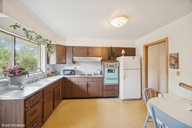 2555 Stratford Ave, Westchester, IL 60154 - kitchen featuring white appliances, under cabinet range hood, light countertops, decorative backsplash, and light flooring