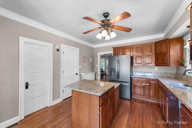 1020 S 4th St, Saint Charles, IL 60174 - kitchen with appliances with stainless steel finishes, dark wood-type flooring, a ceiling fan, a center island, and brown cabinets