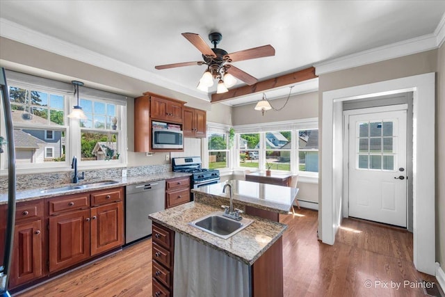 1020 S 4th St, Saint Charles, IL 60174 - kitchen featuring appliances with stainless steel finishes, a kitchen island with sink, light wood finished floors, ceiling fan, and healthy amount of natural light