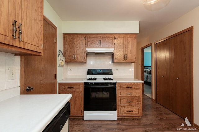 11015 New Mexico Ct, Orland Park, IL 60467 - kitchen with gas range oven, under cabinet range hood, dark wood finished floors, brown cabinetry, and light countertops