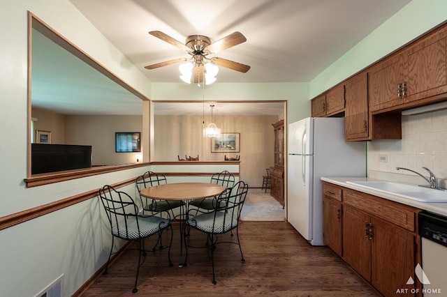 11015 New Mexico Ct, Orland Park, IL 60467 - kitchen featuring white appliances, brown cabinetry, dark wood-type flooring, light countertops, and decorative backsplash