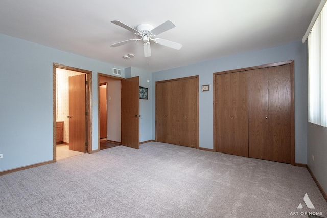 11015 New Mexico Ct, Orland Park, IL 60467 - unfurnished bedroom featuring two closets, carpet floors, a ceiling fan, and ensuite bathroom