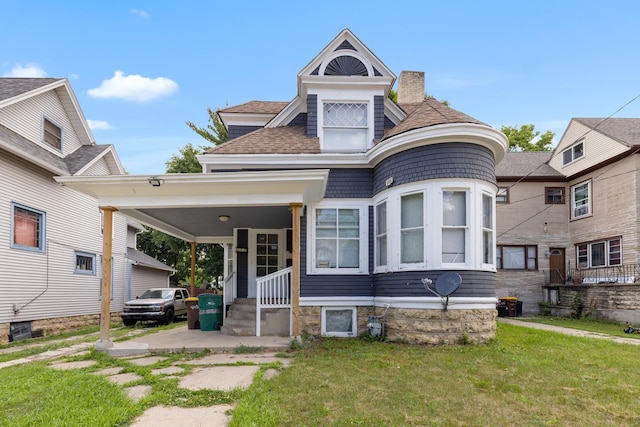 844 Haskell Ave, Rockford, IL 61103 - view of front of house with a front lawn, a chimney, and a shingled roof
