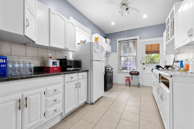 844 Haskell Ave, Rockford, IL 61103 - kitchen featuring stainless steel microwave, ceiling fan, range with gas cooktop, white cabinetry, and backsplash