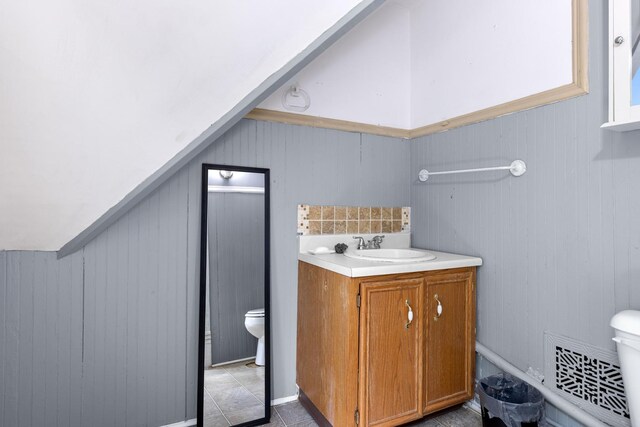 844 Haskell Ave, Rockford, IL 61103 - bathroom featuring vanity, tile patterned floors, and wooden walls