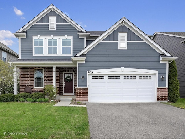 257 Kennedy Dr, Saint Charles, IL 60175 - view of front of home featuring brick siding, board and batten siding, driveway, and a front yard