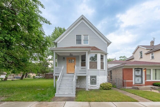 8007 S Avalon Ave, Chicago, IL 60619 - view of front of property featuring stairway, a front lawn, and a porch