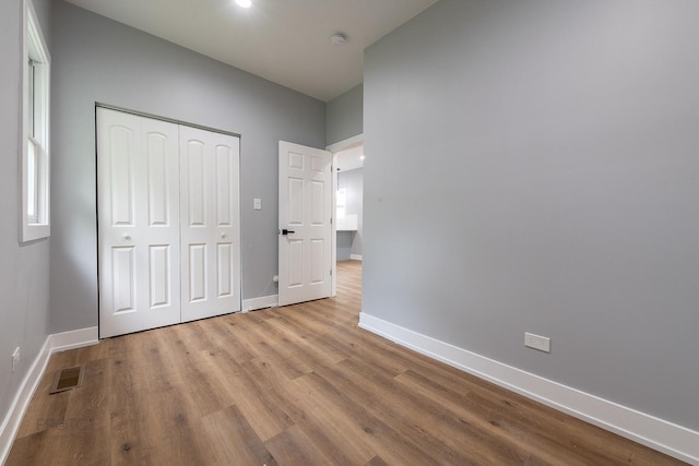 8007 S Avalon Ave, Chicago, IL 60619 - unfurnished bedroom with wood finished floors and a closet