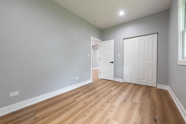 8007 S Avalon Ave, Chicago, IL 60619 - unfurnished bedroom with light wood-type flooring, a closet, and recessed lighting