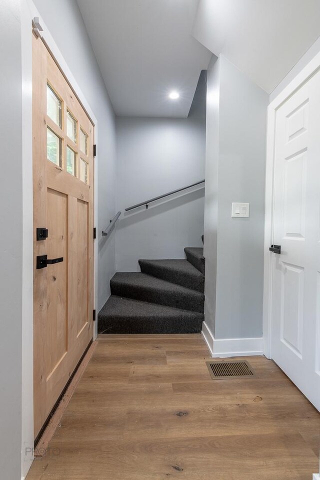 8007 S Avalon Ave, Chicago, IL 60619 - foyer entrance featuring stairs, wood finished floors, and recessed lighting