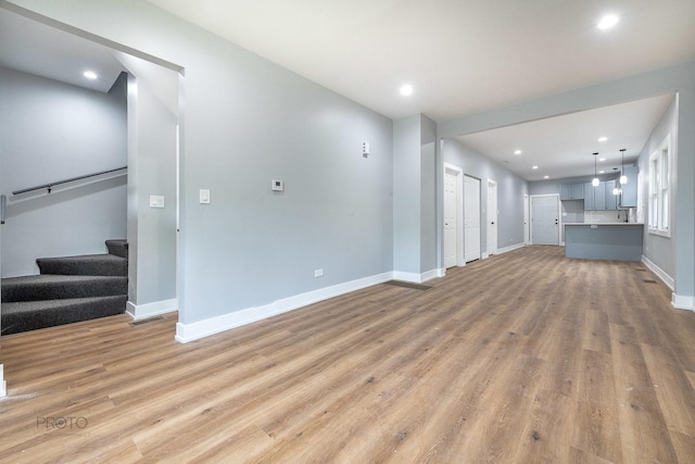 8007 S Avalon Ave, Chicago, IL 60619 - unfurnished living room with light wood-style flooring, stairway, and recessed lighting