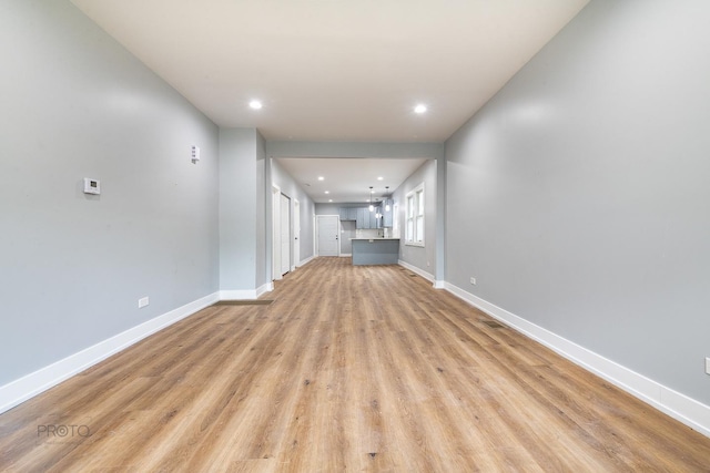8007 S Avalon Ave, Chicago, IL 60619 - unfurnished living room with light wood finished floors and recessed lighting