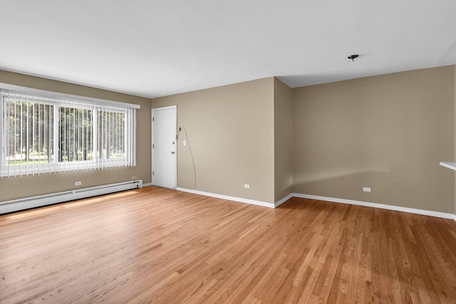 7952 Madison St Unit 2E, River Forest, IL 60305 - spare room featuring light wood-style floors and a baseboard heating unit