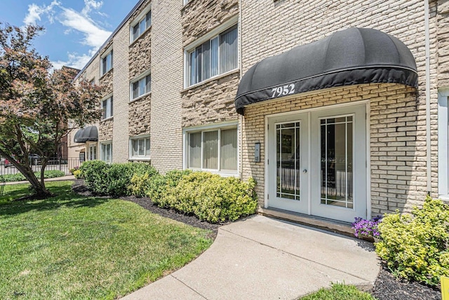 7952 Madison St Unit 2E, River Forest, IL 60305 - entrance to property featuring french doors, brick siding, and a yard