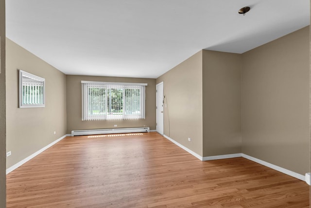 7952 Madison St Unit 2E, River Forest, IL 60305 - unfurnished room with baseboard heating and light wood-style floors