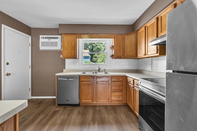 7952 Madison St Unit 2E, River Forest, IL 60305 - kitchen featuring appliances with stainless steel finishes, under cabinet range hood, wood finished floors, and light countertops