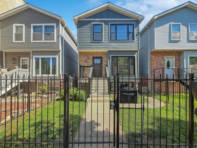 2514 W Washington Blvd, Chicago, IL 60612 - colonial home with a fenced front yard, a gate, and brick siding