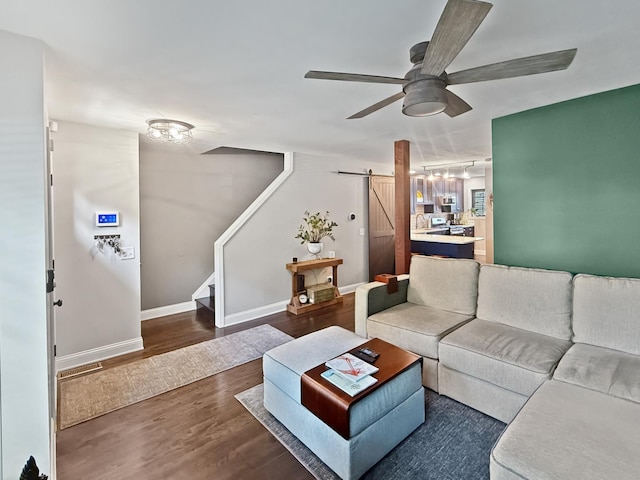 2514 W Washington Blvd, Chicago, IL 60612 - living room with a barn door, dark wood-type flooring, ceiling fan, and stairs