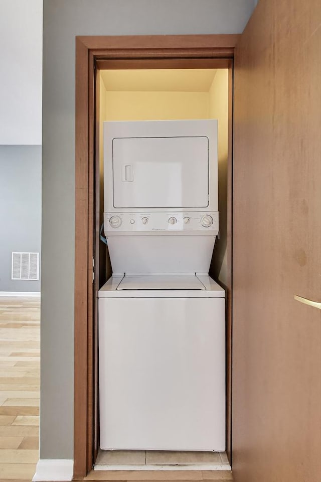 3109 W Argyle St Unit 3, Chicago, IL 60625 - laundry area featuring estacked washer and dryer and wood finished floors
