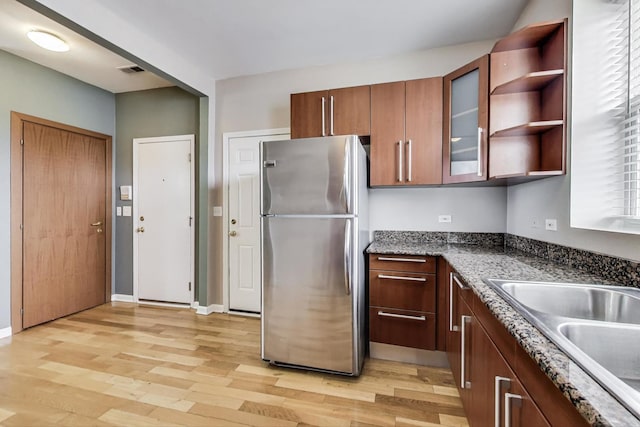 3109 W Argyle St Unit 3, Chicago, IL 60625 - kitchen featuring freestanding refrigerator, light wood finished floors, glass insert cabinets, and open shelves