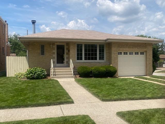 10900 S Tripp Ave, Oak Lawn, IL 60453 - view of front of house with an attached garage and brick siding