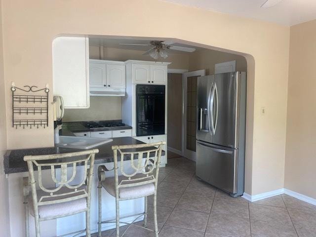 10900 S Tripp Ave, Oak Lawn, IL 60453 - kitchen with stainless steel fridge, ceiling fan, a peninsula, white cabinets, and dark countertops