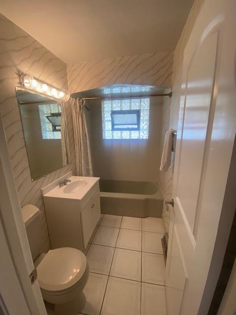 10900 S Tripp Ave, Oak Lawn, IL 60453 - bathroom featuring vanity, tile patterned flooring, and shower / bath combination with curtain