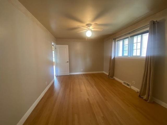 10900 S Tripp Ave, Oak Lawn, IL 60453 - unfurnished room with light wood-type flooring and a ceiling fan