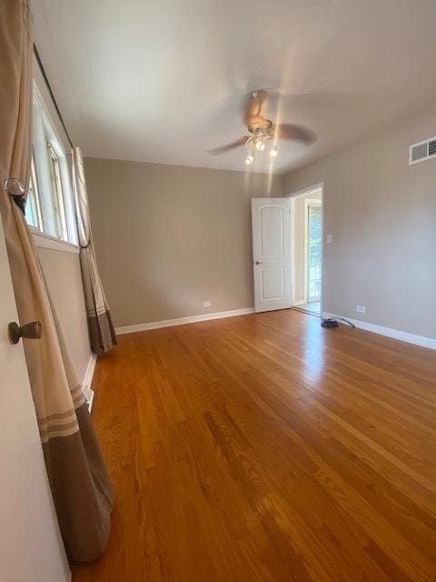 10900 S Tripp Ave, Oak Lawn, IL 60453 - unfurnished bedroom featuring light wood-style floors and a ceiling fan